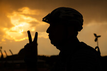 Mountain Biker In Helmet Making Victory And Peace Sign With Fingers.