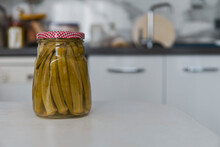 Pickled Okra In Home Kitchen, Pickled Okra And Kitchen In The Background, Selective Focus