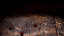Ripe Fresh Cranberries Falling Down On The Dark Wooden Rustic Table. Stock Footage. Close Up Of Wooden Surface And Falling Red Berries.