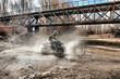 © Agustin - Quad ride along the river with a splash of water.