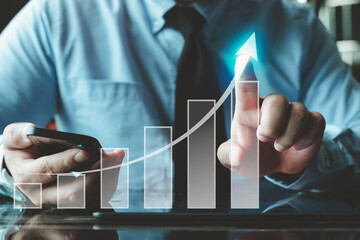 Wall Mural - Businessman touching virtual screen Analyzing financial and investment data, planning strategies to increase sales profits, long-term business plans. .The graph shows the company's growth. profit.