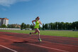 © Tania - woman runs in the stadium.