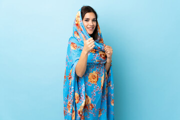 Sticker - Young Moroccan woman with traditional costume isolated on blue background with thumbs up because something good has happened