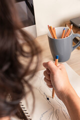 Angry man holding strongly colored pencil