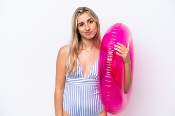 Wall Mural - Young caucasian woman holding air mattress donut isolated on white background with sad expression