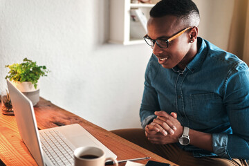 Aufkleber - Male online worker on his computer working freelance sitting in a home office alone. Casual digital employee reading and looking at tech and web research. Young modern man doing a remote tech job