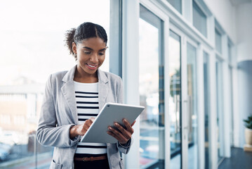 Poster - One young corporate intern worker browsing on wireless technology. Smiling businesswoman working on a tablet, reading email message online or checking company SEO website data in modern office.