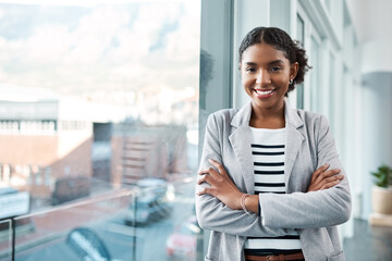 Aufkleber - Young, confident and ambitious business woman or corporate professional standing arms crossed by an office window in the city. Portrait of a happy female ready for success and looking positive