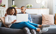 © D Donson/peopleimages.com - Happy, relaxed and carefree couple bonding together on the sofa in the living room at home. Loving, affectionate and smiling boyfriend and girlfriend relaxing, typing and browsing on a laptop