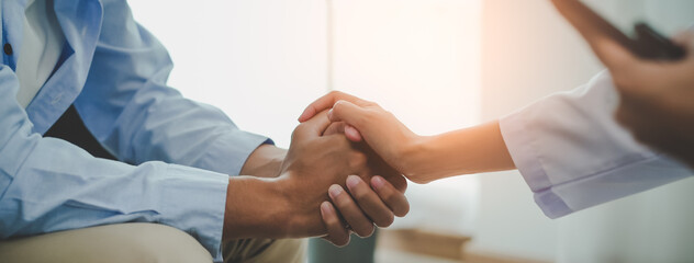 psychologist touching patient hands during talking therapy stressed mental health at office