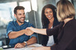 © Daniel Laflor/peopleimages.com - Handshake and teamwork by business people, colleagues and coworkers in a meeting, discussion or negotiating at work. Corporate professionals greet, make a deal and collaborate in an office boardroom