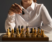 Faceless Caucasian Woman In White Shirt Playing Chess. 