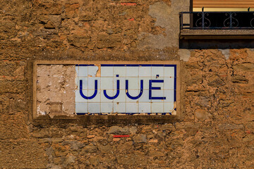 Poster - Old tile sign with the village name in the medieval village of Ujue, Spain