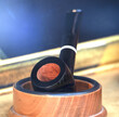 dark smoking pipe with briar stove in the wooden container