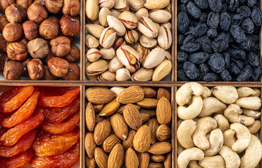 Wall Mural - assorted nuts and dried fruit collection. Assorted nuts almonds, pistachio, cashews, walnut. Organic mixed nuts background. Healthy food, useful microelements and vitamins.
