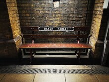 Old And Vintage Bench In Baker Street Underground Station, In A Dark And Mysterious Atmosphere, London, England, United Kingdom.