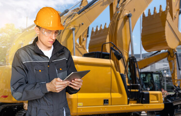 Aufkleber - Engineer in a helmet with a digital tablet on the background of construction machines