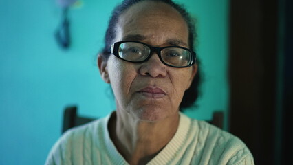 Wall Mural - An African American senior woman portrait closeup face. A black elderly hispanic person