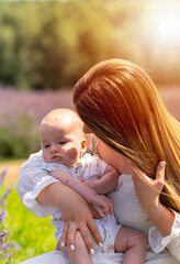 Backlit portrait if a loving mother and baby