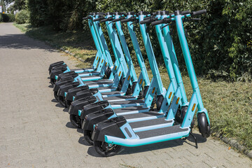 Electric scooters for public share standing outside in european city center public mobile transport