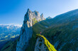 © AmazingAerialAgency - Aerial view of a person on a mountain peak on Swiss Alps, Sax, St. Gallen, Switzerland.