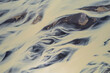 © AmazingAerialAgency - Aerial view of a water abstract pattern from a river estuary in Iceland.