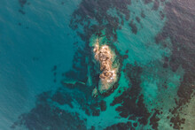 Aerial View Of A Sunken Shipwreck Near The Rocks Along The Coast In Pomonte, Elba Island, Tuscany, Italy.