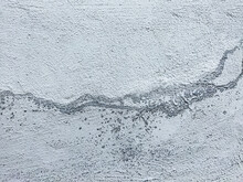 Textured Concrete Wall With White And Blue Streaks And Gray Stripes. Small Gray Droplets On The Surface. Concrete Background