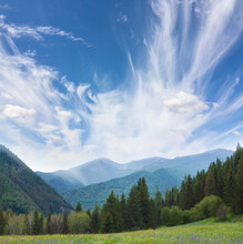 Green Mountain Chain Under Blue Cloudy Sky