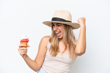 Wall Mural - Young caucasian woman with a cornet ice cream isolated on white background celebrating a victory