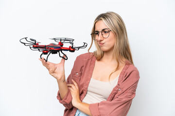 Wall Mural - Woman holding a drone over isolated background with sad expression