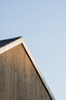 Facade and tood of a modern wooden single family house in the sunset