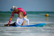 little girl has fun on vacation with surf lessons