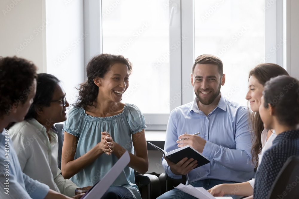 Smiling multiracial colleagues have fun take part in educational ...