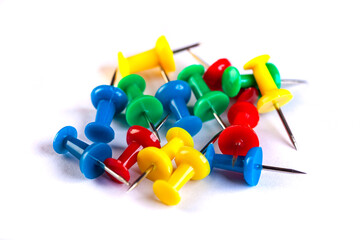 Closeup of Many Colored Thumbtacks on White