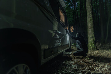 Robber Trying to Break the Lock of the Motorhome Vehicle