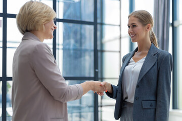 Poster - Image of two business women shaking hands after set a deal.