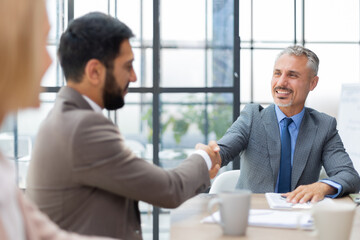 Business people shaking hands, finishing up a meeting.