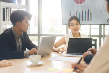 Wall Mural - Young adult business woman using laptop presentation data in boardroom workplace