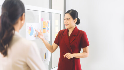 Sticker - Busy young adult business asian woman expand analysis finance graph on glass board at indoor office