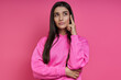 © gstockstudio - Thoughtful young woman looking away while standing against pink background