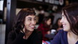 © Marco - Two female friends in conversation and talk at restaurant sharing gossip