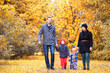 Family in autumn park in the afternoon