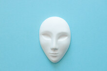 White Gypsum Mask Of Human With Closed Eyes On Blue Background