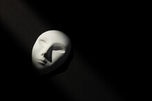 White Gypsum Mask Of Human With Closed Eyes On Black Background