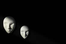 Two White Gypsum Mask Of Human With Closed Eyes On Black Background