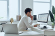 © gstockstudio - Thoughtful man in shirt and tie using computer while sitting at his working place in office