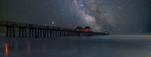 Milky Way Over The Seashore And Famous Wooden Pier In Perspective. Old Naples Pier, Florida, USA