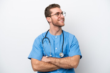 Wall Mural - Young surgeon doctor caucasian man isolated on white background happy and smiling