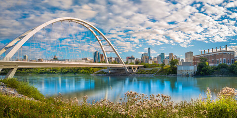 Wall Mural - Edmonton cityscape and Walterdale Bridge over North Saskatchewan River in Alberta, Canada. Sunrise river trail landscape and cloudscape at Queen Elizabeth Park.